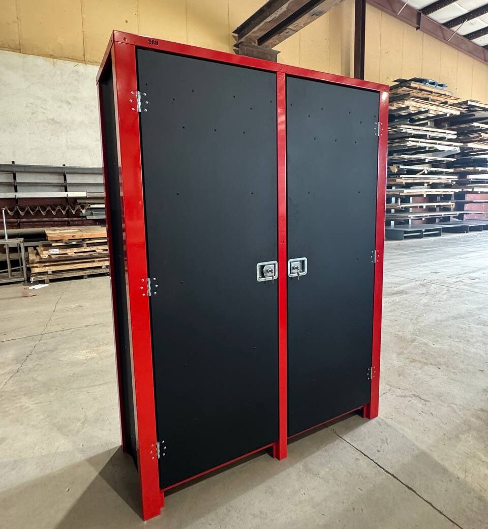 tall black cabinet with red strip in a warehouse
